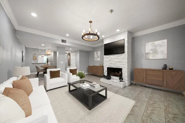 a living room with furniture a fireplace and a flat screen tv