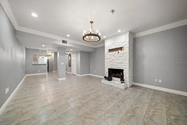 a view of an empty room and fire place