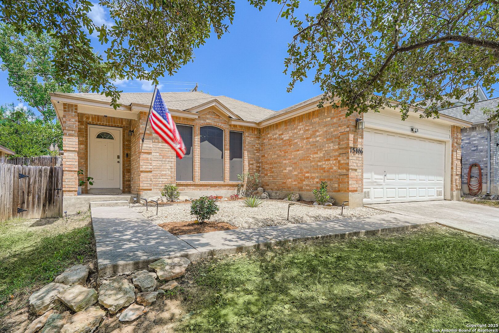 15406 Spring Dew San Antonio, TX 78247 - Photo 1 of 26 a front view of a house with a yard and garage