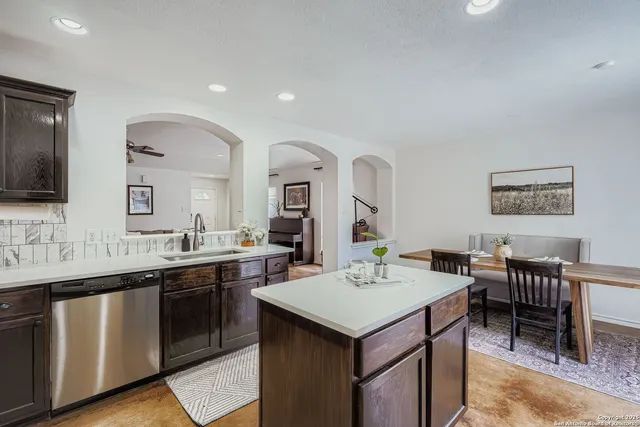 a view of a kitchen area with furniture and sink