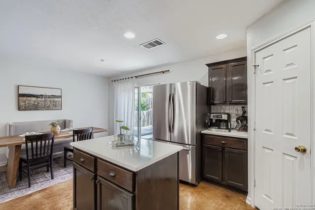 a kitchen with stainless steel appliances a sink stove and refrigerator