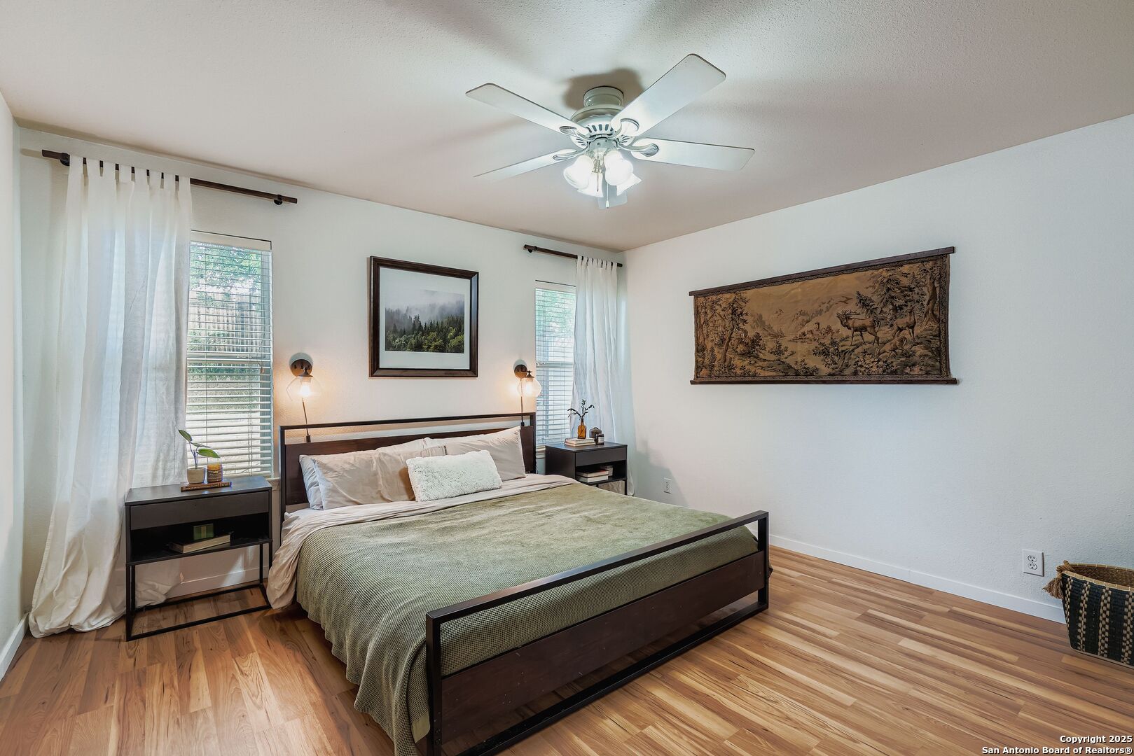 15406 Spring Dew San Antonio, TX 78247 - Photo 13 of 26 a bedroom with a large bed and a chandelier