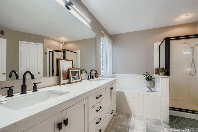 a bathroom with a double vanity sink mirror and