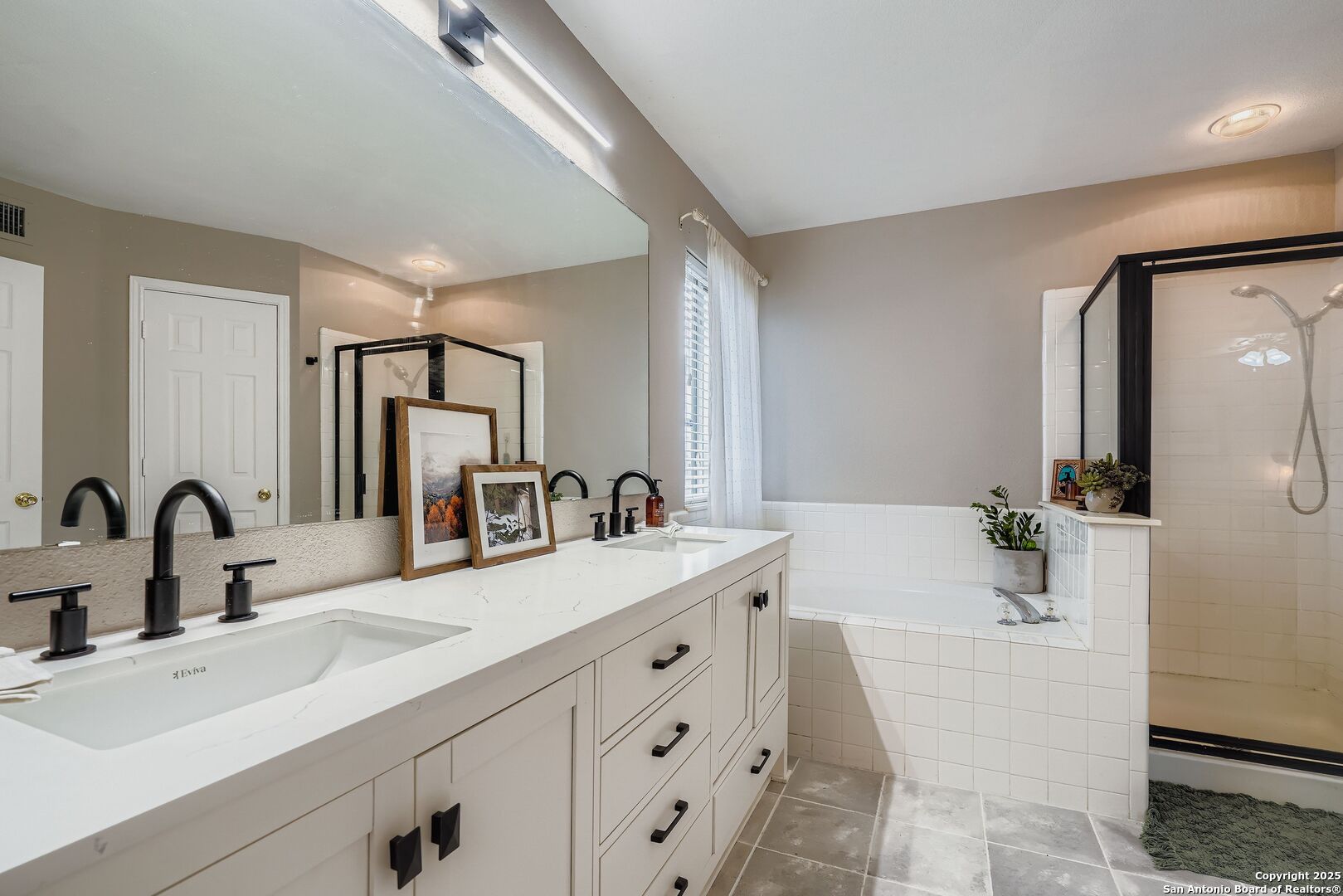 15406 Spring Dew San Antonio, TX 78247 - Photo 16 of 26 a bathroom with a double vanity sink mirror and