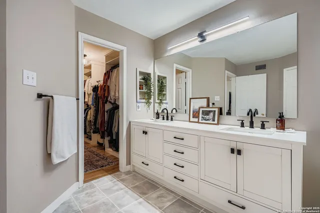 a bathroom with a sink a mirror and shower