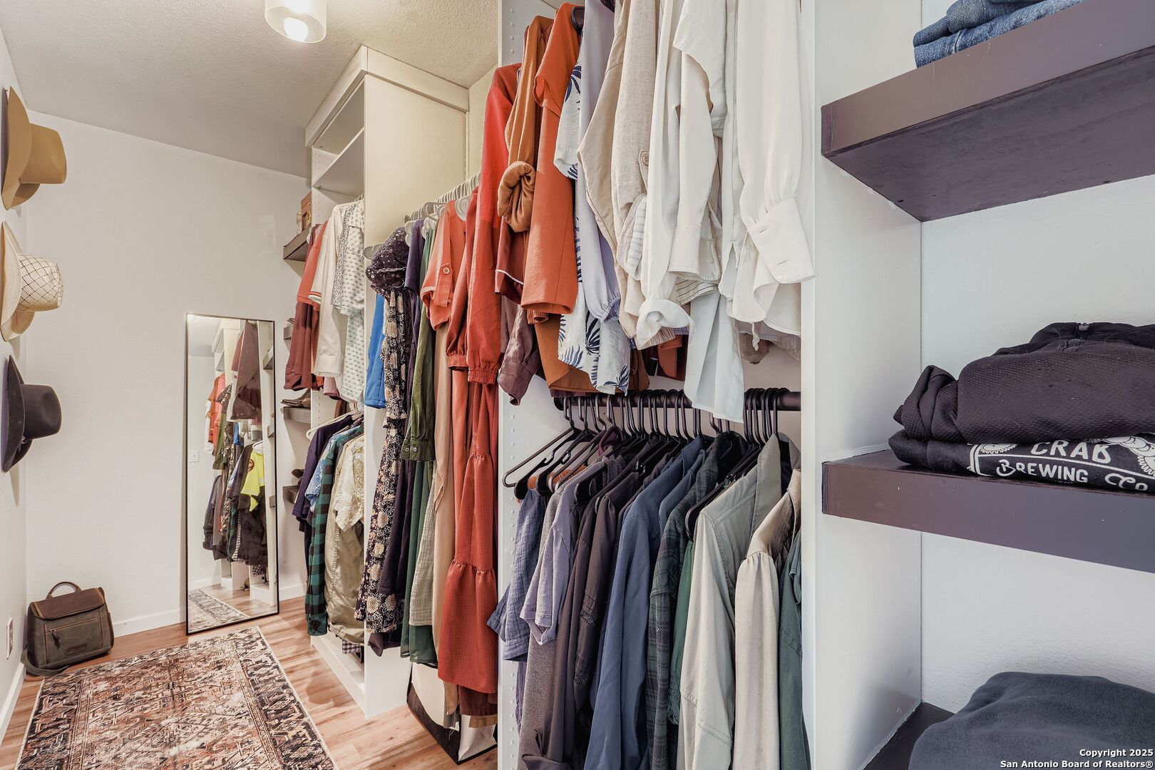 15406 Spring Dew San Antonio, TX 78247 - Photo 18 of 26 a view of walk in closet with clothes and shoes