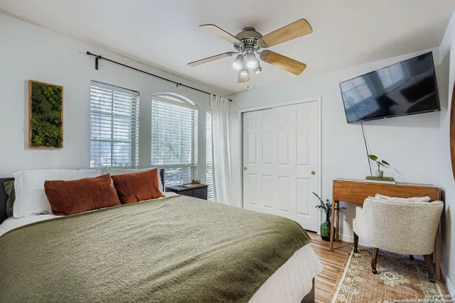 a bedroom with a bed and a flat screen tv