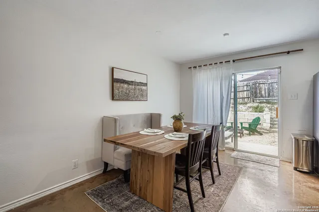 a view of a dining room with furniture and a window