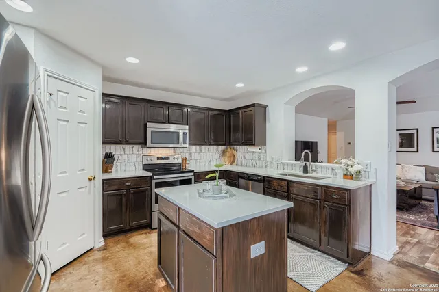 a kitchen with a sink stove and refrigerator