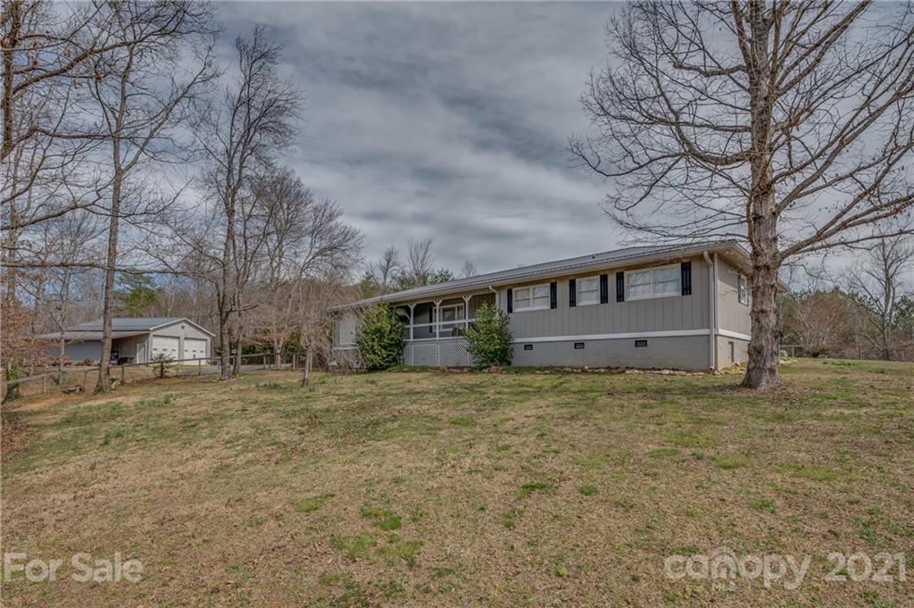 50 Owl Hollow Road Mill Spring, NC 28756 - Photo 1 of 45 a big house with large tree in front of it