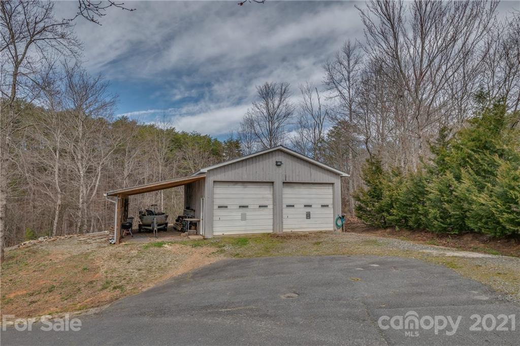 50 Owl Hollow Road Mill Spring, NC 28756 - Photo 13 of 45 a view of a house with large trees