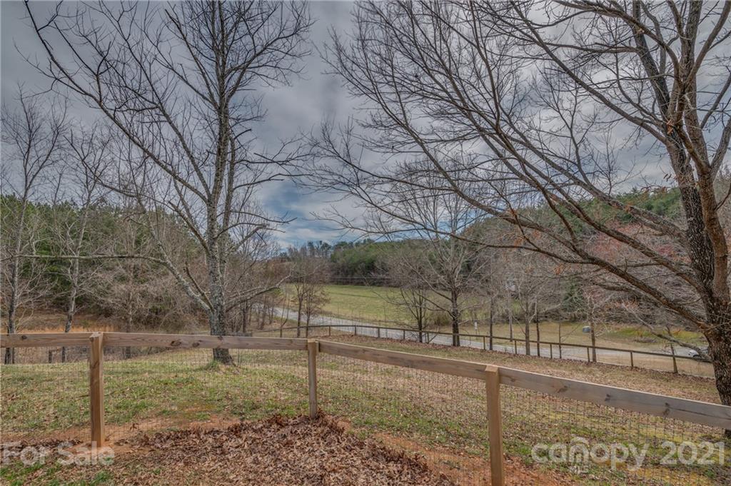 50 Owl Hollow Road Mill Spring, NC 28756 - Photo 20 of 45 a view of a yard covered with snow in the yard
