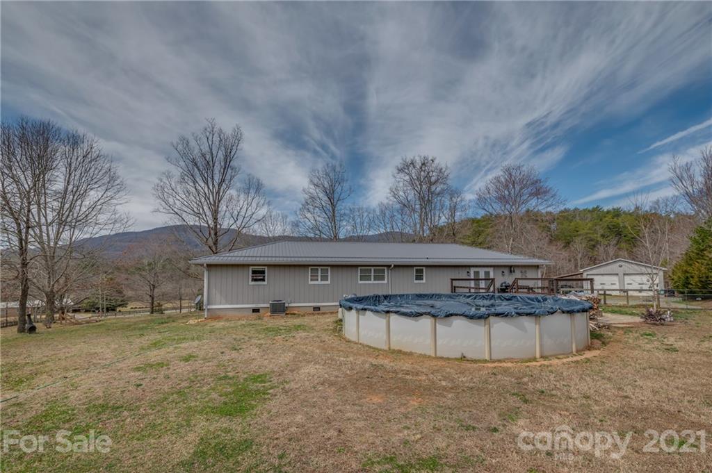 50 Owl Hollow Road Mill Spring, NC 28756 - Photo 21 of 45 a view of a house with a yard and sitting area