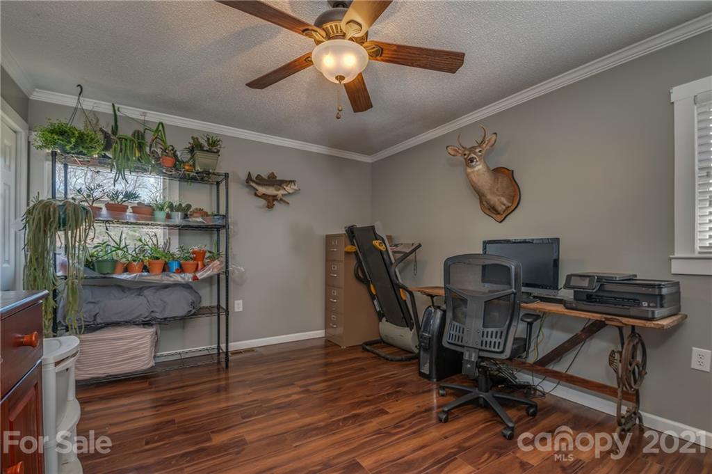 50 Owl Hollow Road Mill Spring, NC 28756 - Photo 23 of 45 a view of a dining room with furniture and wooden floor