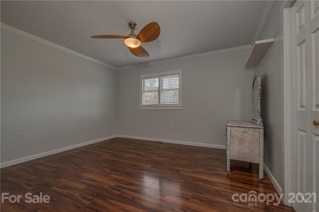50 Owl Hollow Road Mill Spring, NC 28756 - Photo 10 of 45 an empty room with wooden floor and windows
