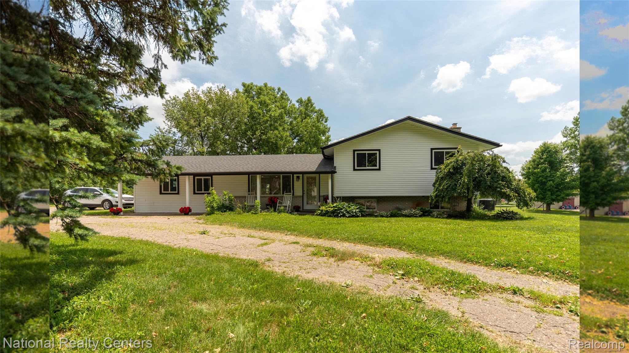 58191 8 Mile Road Northville, MI 48167 - Photo 8 of 57 White exterior with dark trim and a covered front porch featuring white support columns