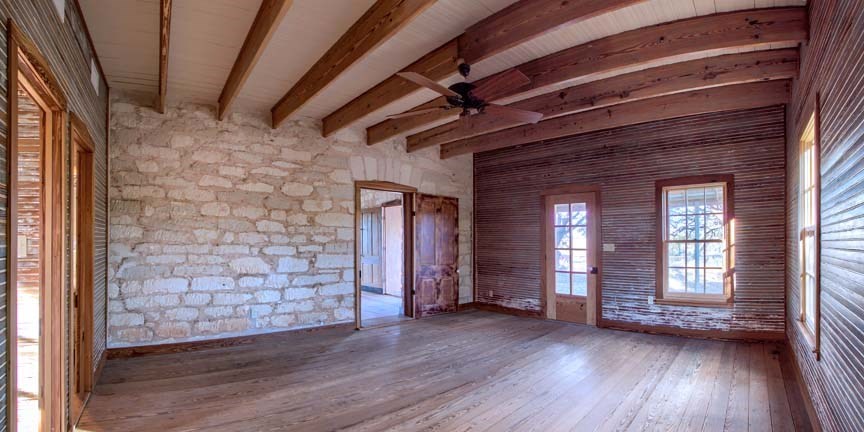 3610 Welgehausen Road Fredericksburg, TX 78624 - Photo 4 of 43 a view of an empty room with wooden floor and a window