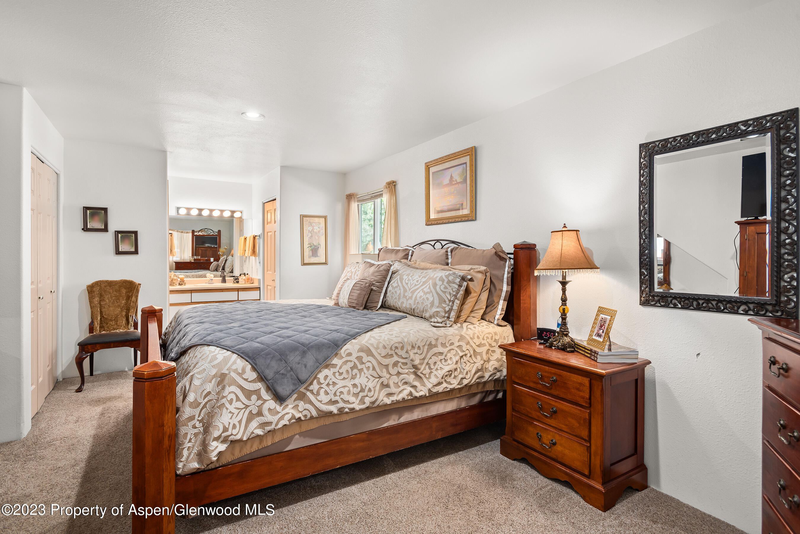 141-143 Swinging Bridge Lane Basalt, CO 81621 - Photo 25 of 35 a bedroom with a bed and dresser with mirror