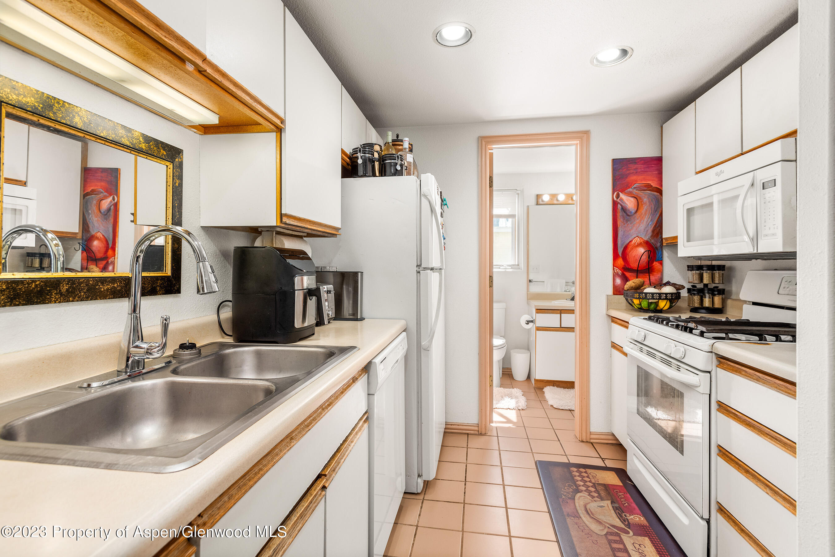 141-143 Swinging Bridge Lane Basalt, CO 81621 - Photo 7 of 35 a kitchen with stainless steel appliances granite countertop a sink stove and refrigerator
