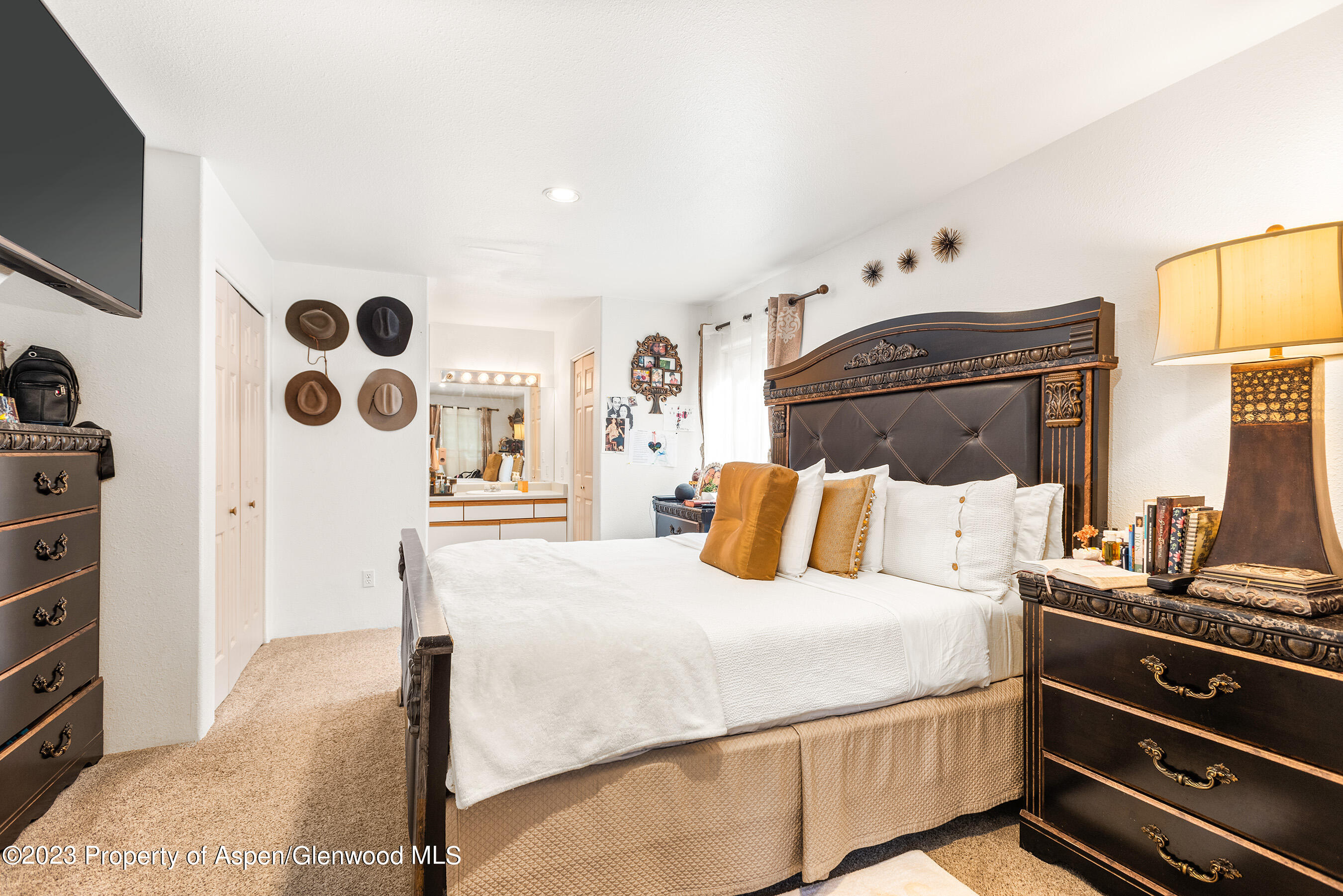 141-143 Swinging Bridge Lane Basalt, CO 81621 - Photo 9 of 35 a bedroom with a bed and a flat tv screen on dresser