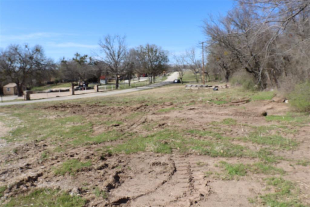 1616 Oliver Street Weatherford, TX 76086 - Photo 3 of 15 a view of dirt yard with a large tree