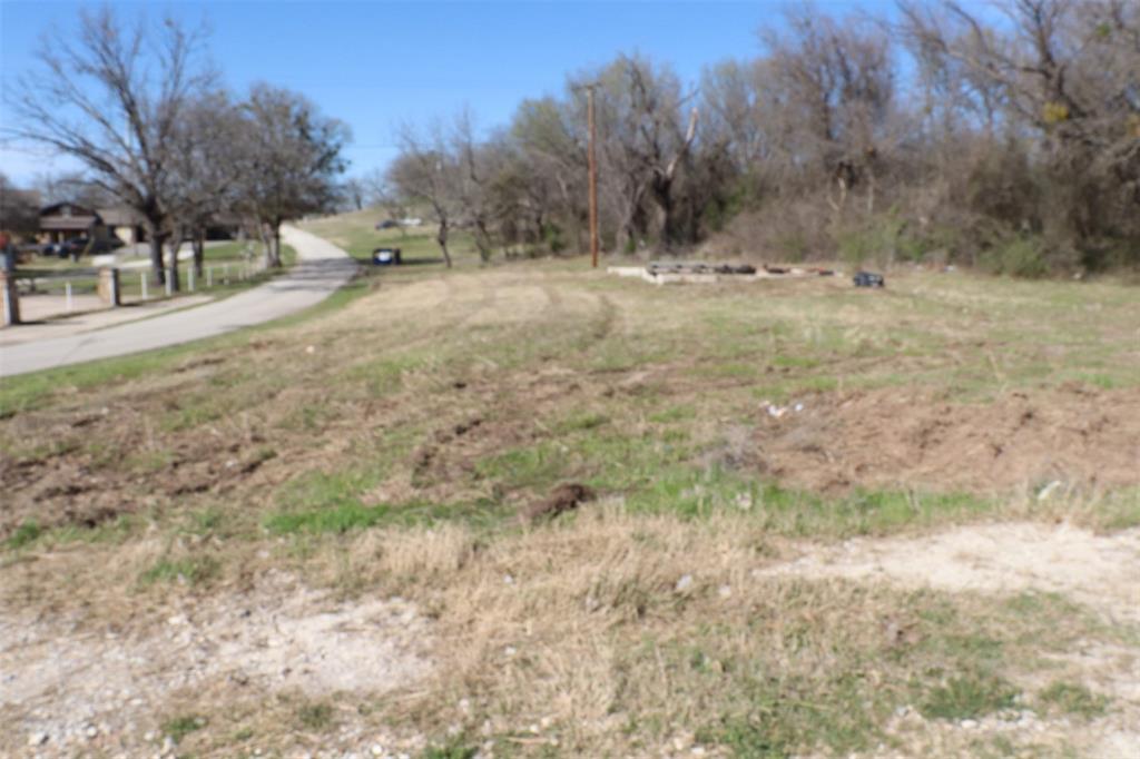 1616 Oliver Street Weatherford, TX 76086 - Photo 8 of 15 a view of dirt yard with a tree