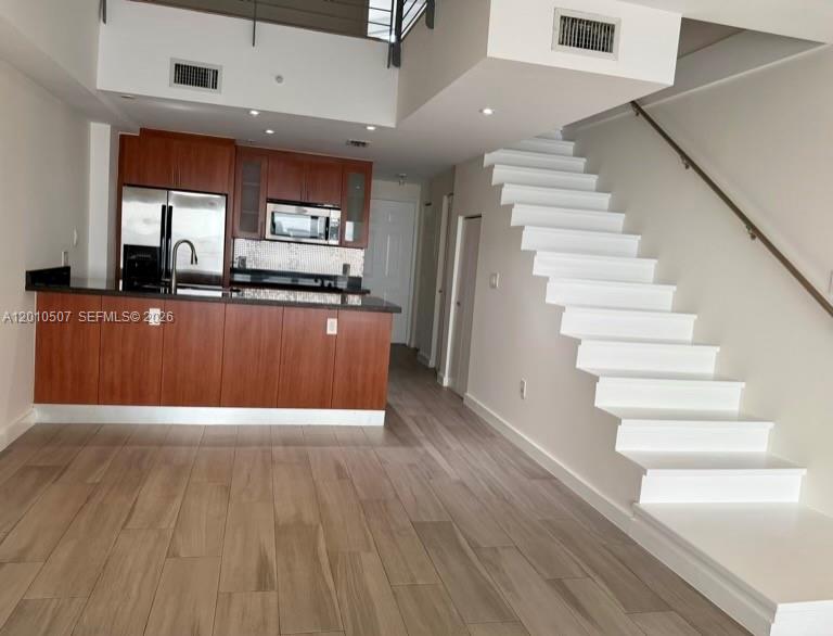 1712 Southwest 2nd Avenue, Unit 304 Miami, FL 33129 - Photo 2 of 18 a view of kitchen with furniture and wooden floor