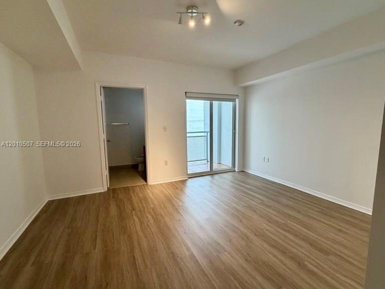 1712 Southwest 2nd Avenue, Unit 304 Miami, FL 33129 - Photo 9 of 18 wooden floor in an empty room with a window