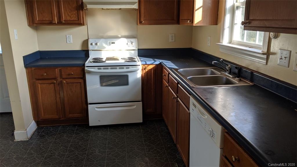 336 Landfill Road Jefferson, SC 29718 - Photo 7 of 9 a kitchen with granite countertop stainless steel appliances a stove sink and cabinets