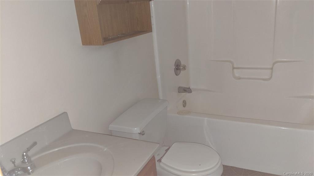 336 Landfill Road Jefferson, SC 29718 - Photo 8 of 9 a white toilet and tub sitting next to a shower
