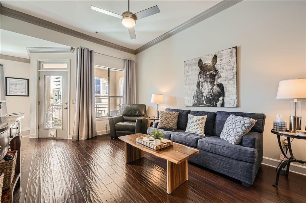 a living room with furniture and a wooden floor