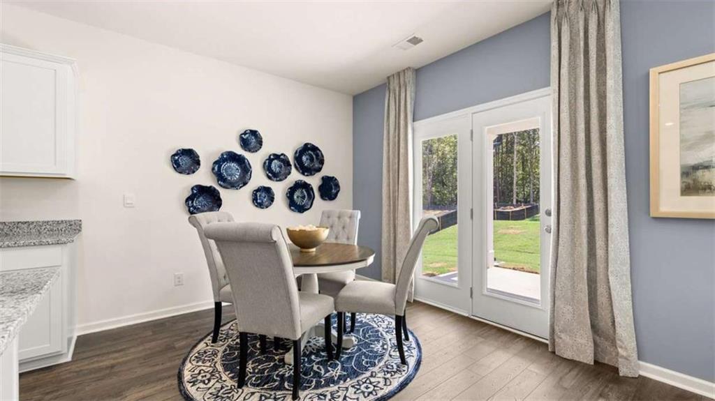 476 Bullock Pass Jefferson, GA 30549 - Photo 15 of 66 a view of a dining room with furniture and wooden floor