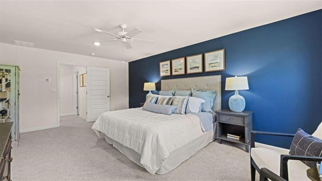476 Bullock Pass Jefferson, GA 30549 - Photo 28 of 66 a bedroom with a large bed and a chandelier