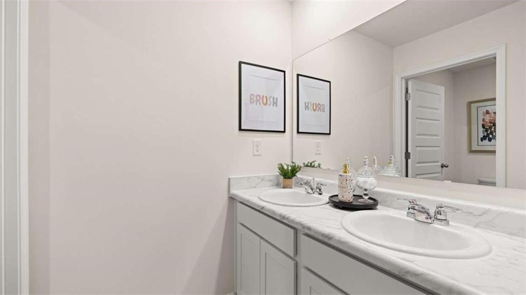 476 Bullock Pass Jefferson, GA 30549 - Photo 46 of 66 a bathroom with 2 sink and a mirror