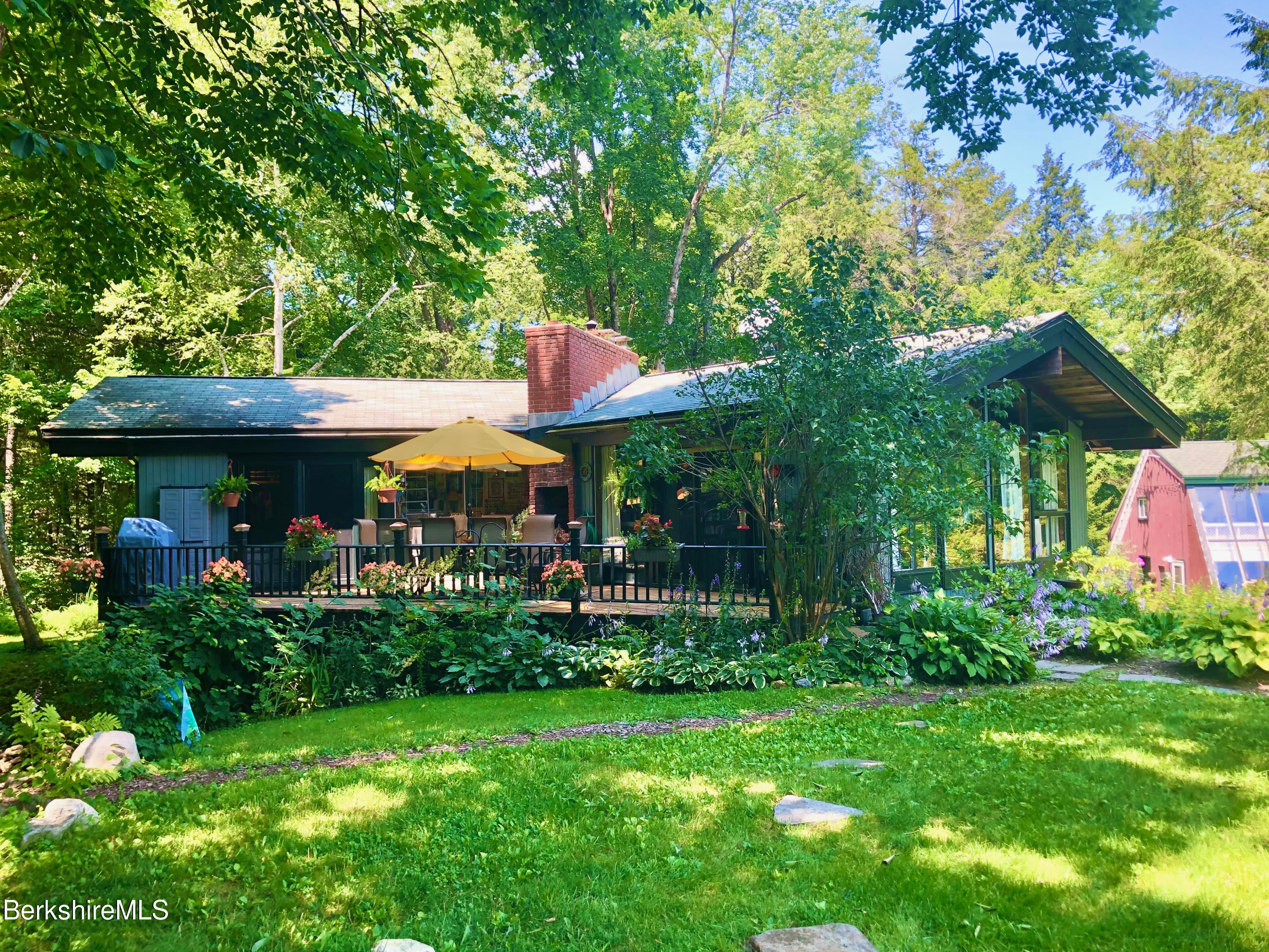 82 Beaver Hill Road Otis, MA 01253 - Photo 3 of 49 a view of a table and chairs under an umbrella