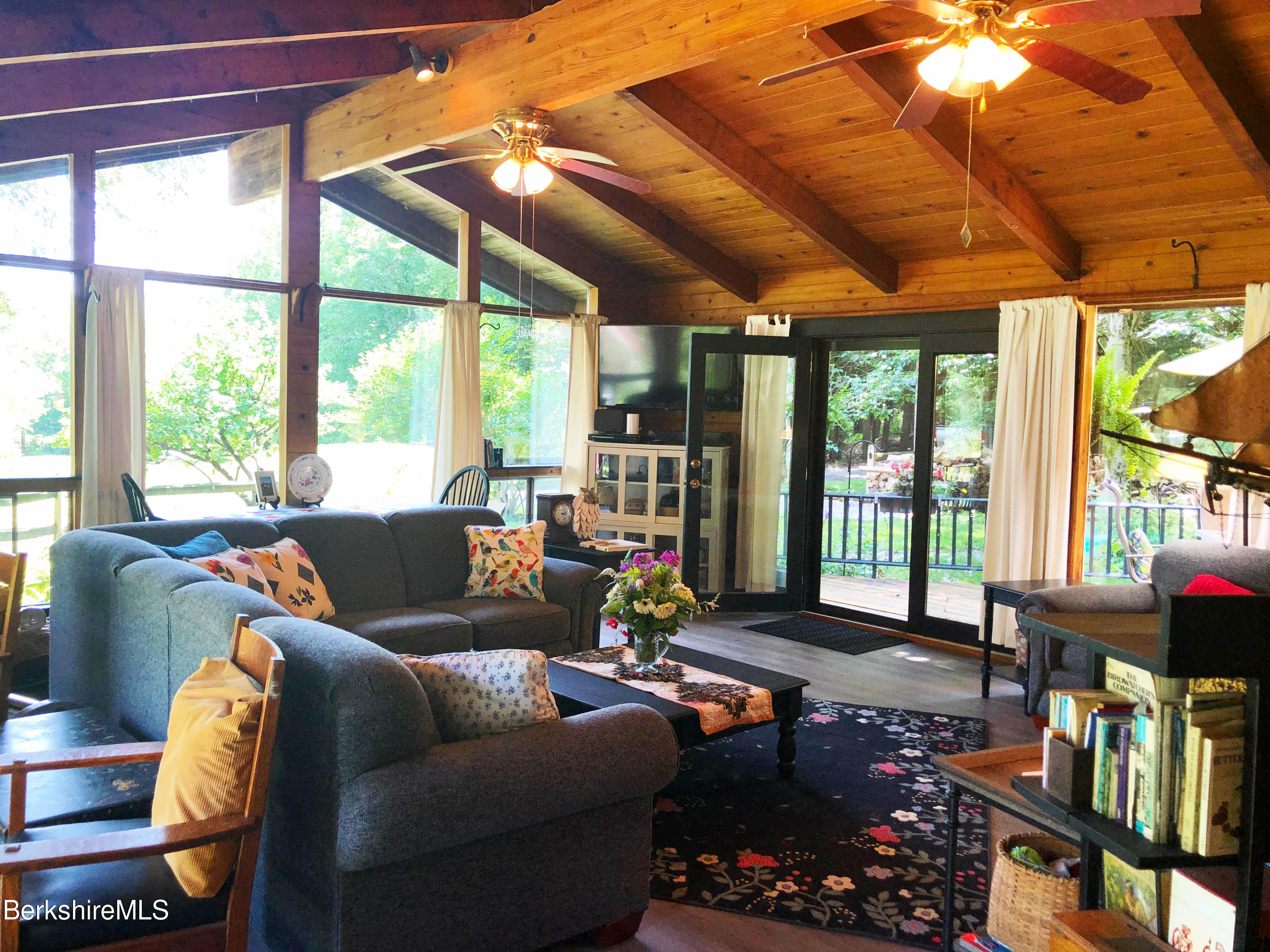82 Beaver Hill Road Otis, MA 01253 - Photo 8 of 49 a living room with furniture a bookshelf and a large window