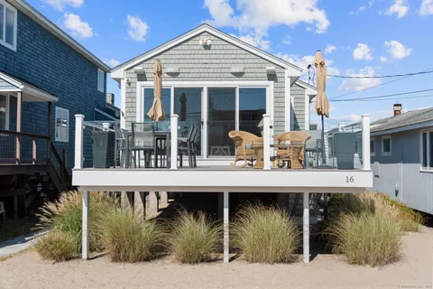 a view of a house with floor to ceiling windows and a basket ball poll