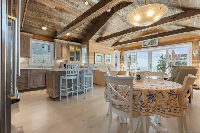 a view of a dining room with furniture and chandelier