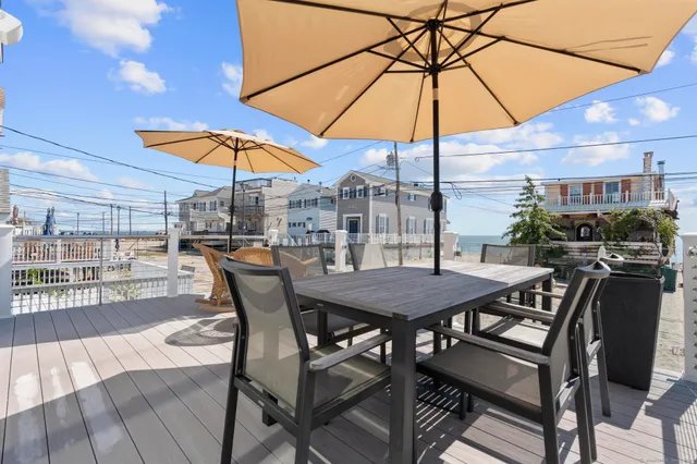 a patio with a table and chairs under an umbrella
