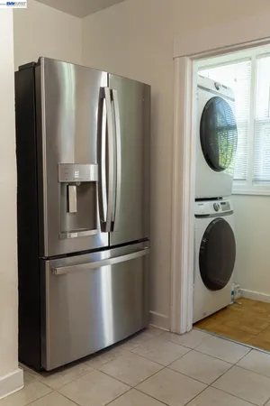a view of a kitchen with a refrigerator and washer