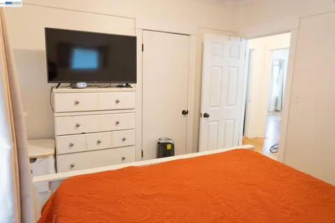 a bedroom with a bed and flat screen tv