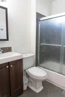 a bathroom with a toilet a sink and shower