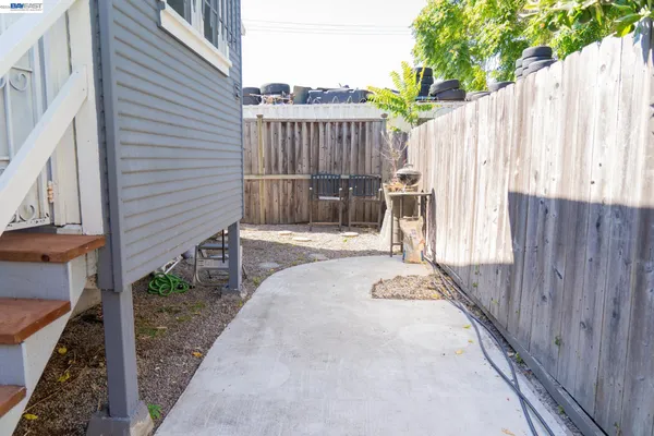 a view of a backyard with wooden fence