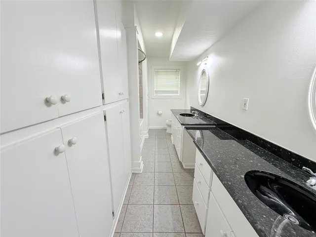 a kitchen with granite countertop a stove and a refrigerator