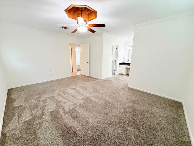 a view of room and chandelier fan