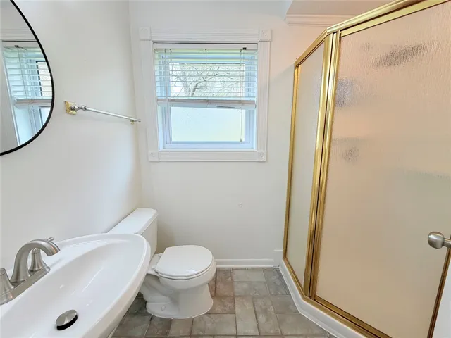 a white toilet sitting next to a bathroom sink