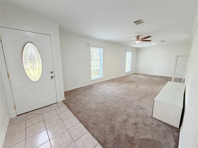 a view of a livingroom with wooden floor and a large window