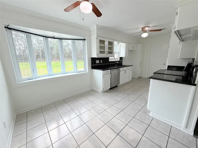 a kitchen with a sink a counter top space and appliances