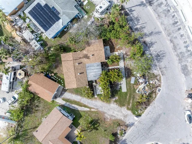 an aerial view of a house with a yard and garden