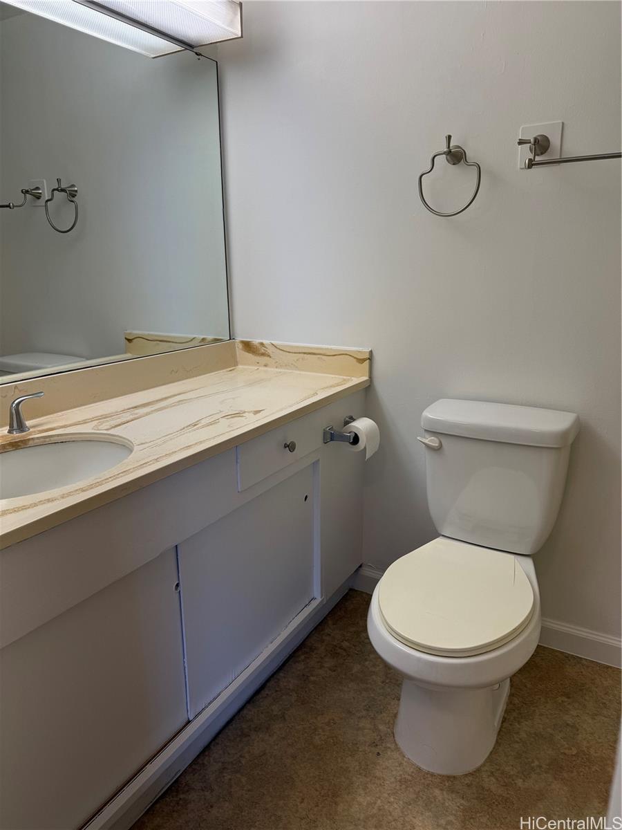 1112 Kinau Street, Unit 807 Honolulu, HI 96814 - Photo 7 of 10 a bathroom with a granite countertop toilet and a sink